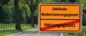 Orangefarbenes Ortsschild mit Gebäudemodernisierungsgesetz ersetzt Heizungsgesetz