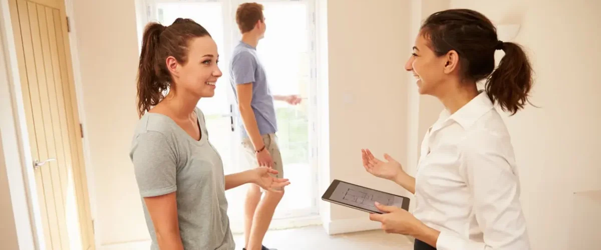 Couple viewing a home interior with an estate agent